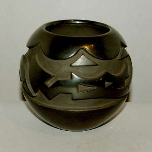Avanyu and cloud design carved in a black jar