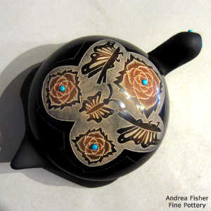 Sgraffito butterfly, flower and geometric design on a carved black turtle