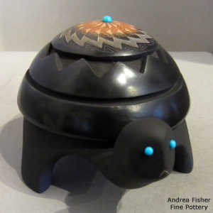 Sgraffito feather and geometric design on a carved black turtle with a sienna spot and inlaid stones