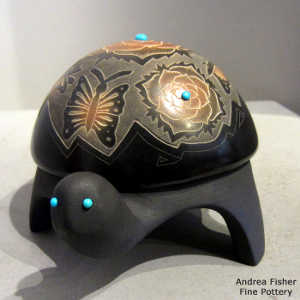 Sgraffito butterfly and flower design with six inlaid stones on a carved black turtle