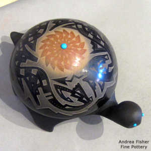 Sgraffito avanyu, feather and geometric design on a carved black turtle with inlaid stones
