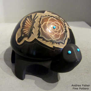 Sgraffito butterfly, flower and geometric design on a carved black turtle with inlaid stones