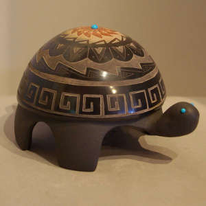Sgraffito geometric designs, sienna spot and inlaid turquoise on a black turtle
