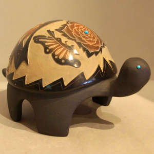 Sgraffito flower and butterfly design plus inlaid turquoise on a carved black turtle