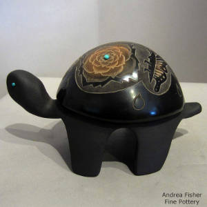 Sgraffito butterfly and flower design with four pieces of inlaid turquoise on a carved black turtle