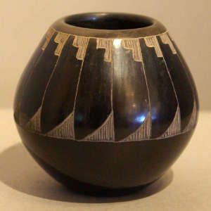 Sgraffito feather design on a black jar