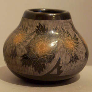 Sgraffito hummingbird and floral motif on a black jar with sienna spots