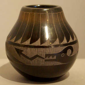 Sgraffito feather and avanyu design on a black jar