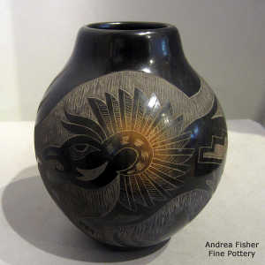 Sgraffito eagle, animal and geometric design on a black jar with sienna spots