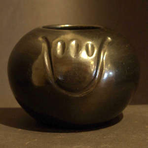 Bear paw imprint on a polished black bowl