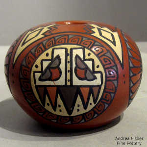 Feather, stormcloud medallion and geometric design on a polychrome seed pot