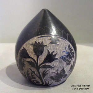 Sgraffito feather, flower, butterfly, bear paw and geometric design on a black seed pot