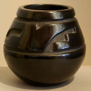 Geometric design carved into a black jar