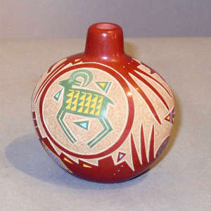 Sgraffito and painted ram and geometric design on a miniature polychrome jar