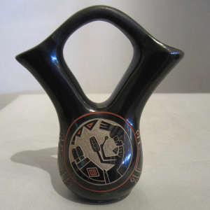 Colored sgraffito design on a black wedding vase