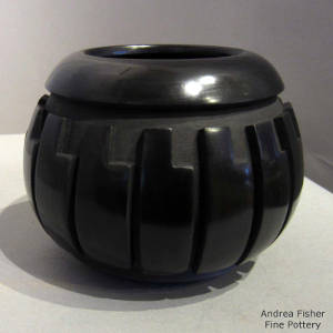 Feather design carved into a black jar