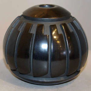 Feather design carved into a black jar