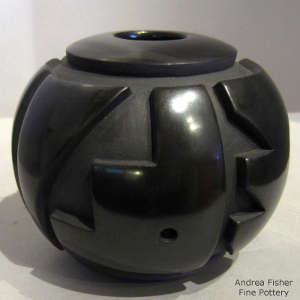 Kiva step and geometric design carved into a polished black jar