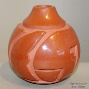 Geometric design carved into a red jar