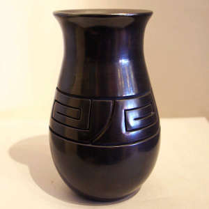 Geometric design carved into a polished black jar