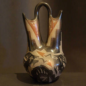 Sgraffito double avanyu and geometric design on a black wedding vase