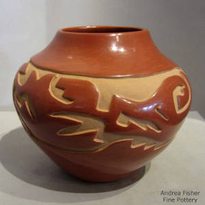 Avanyu design carved into a red jar