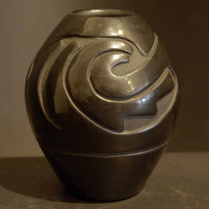 Geometric designs carved into a small black jar