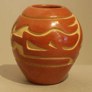 Avanyu design carved into a red jar