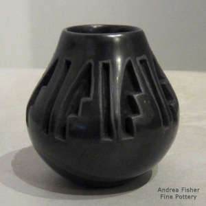 Geometric design carved into a black jar