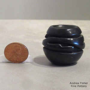 Geometric design carved into a miniature jar