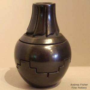 Geometric design carved into a black jar