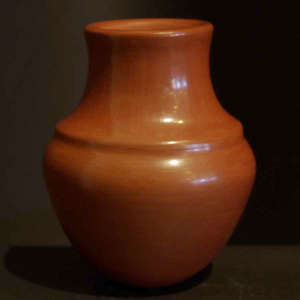 Polished red jar with a double shoulder