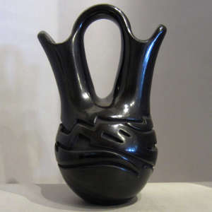 Avanyu design carved into a black wedding vase