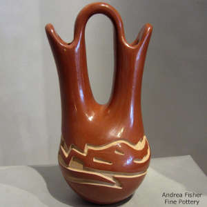 Avanyu design carved into a red wedding vase