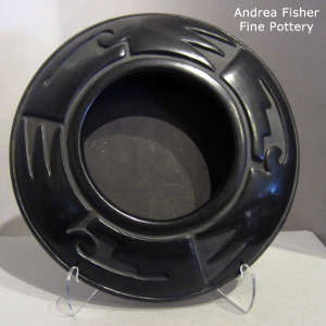 Geometric design carved into a shallow black jar