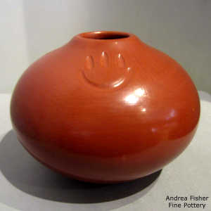 3 bear paw imprints on a polished red jar
