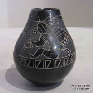 Sgraffito and pianted dancer and geometric design on a miniature black on black jar