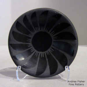 Feather and geometric design on a black on black plate