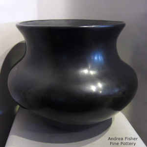 A large plain polished black jar