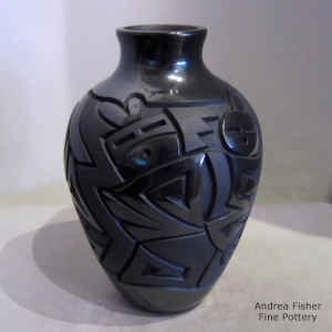 Yei, spiral and geometric design carved into a black on black jar