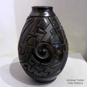 Tularosa spiral, lightning bolt and geometric design carved into a black on black jar