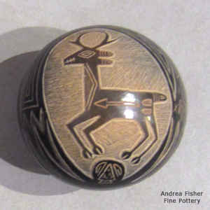 Sgraffito pronghorn, heart line and geometric design on a miniature black seed pot with sienna spots