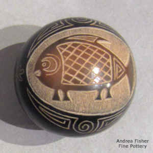 Sgraffito Mimbres-style fish and geometric design on a miniature black seed pot with a sienna spot