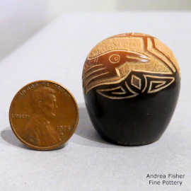 Sgraffito bird and geometric design on a miniature black seed pot with a sienna spot