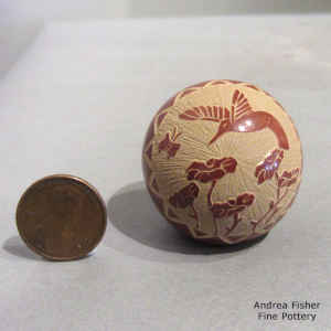 Miniature red seed pot with a sgraffito hummingbird, flower, butterfly and geometric design