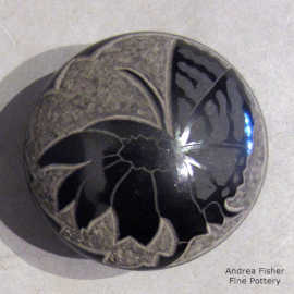 Sgraffito and painted butterfly, flower and geometric design on a miniature black-on-black seed pot