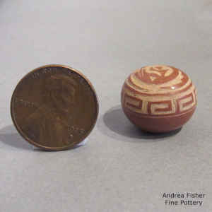 Sgraffito avanyu and geometric design on a miniature red seed pot