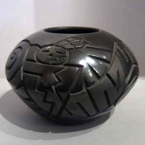 Yei faces, Tularosa spirals and a geometric design carved into a black on black jar