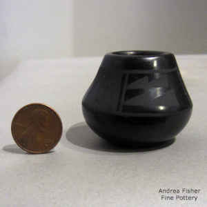 Miniature black on black jar with a geometric design