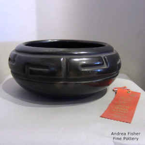 Black bowl carved with a geometric design